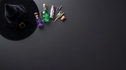 Fototapeta premium Black witch hat with colorful glass potion bottles and dried herbs on a dark table surface