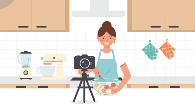 Food blogger recording a cooking demonstration video in a modern kitchen while whisking ingredients in a bowl on a tripod camera.