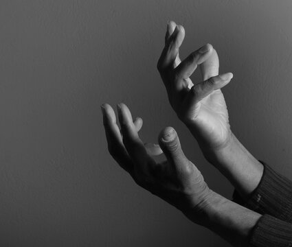 praying to god with hands showing his religious faith with God Caribbean man praying with background with people stock photo stock image