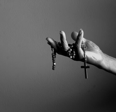 praying to god with hands showing his religious faith with God Caribbean man praying with background with people stock photo stock image