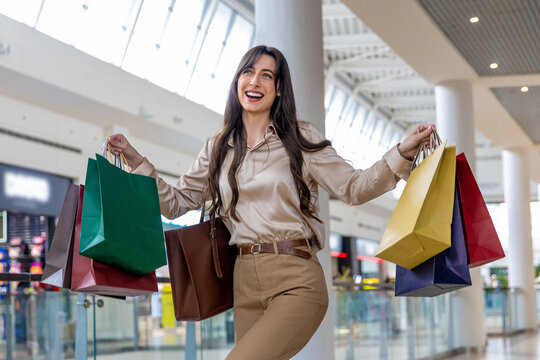 Dark-haired young woman feeling excited after good shopping