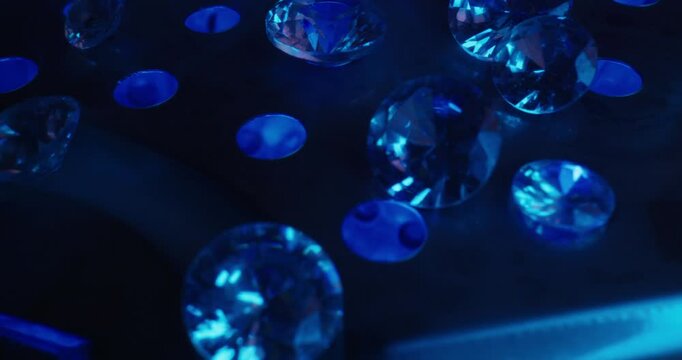 Abstract blue faceted diamonds floating on illuminated surface for dreamy jewelry wallpaper for laboratory mining factory.