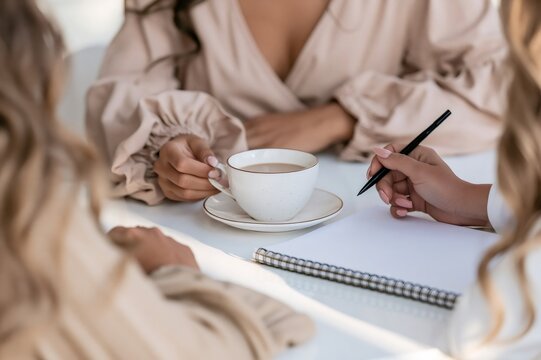 Women brainstorming business ideas over coffee