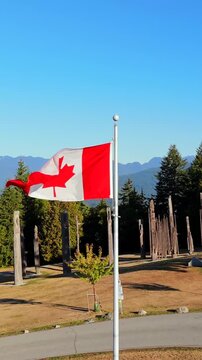 Aerial shot showing Canadian flag waving in the wind on Canada Day