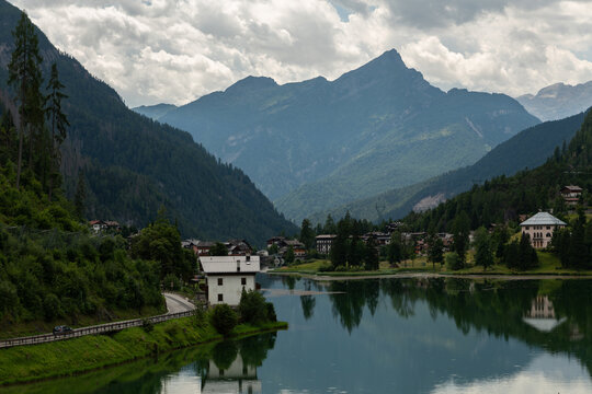 Alleghe, Italy. Alpine lake and mountain village surrounded by forested Dolomite peaks