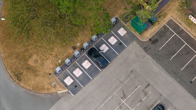 Aerial view of Corley Northbound Services M6 showing electric vehicle charging zones with a parked car in Coventry, England, United Kingdom.