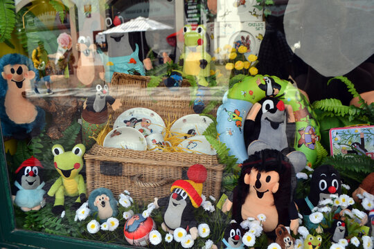PRAGUE, CZECH REPUBLIC - JULY, 02, 2026. Shop window plush characters The Little Mole - Krtek display with colorful stuffed mole and animal toys arranged with daisies 