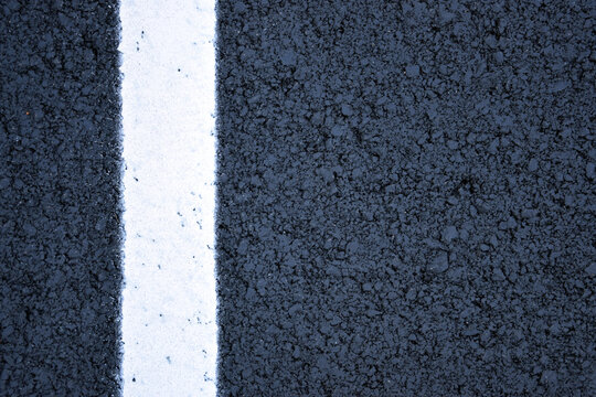  New black asphalt texture with white road marking line close up