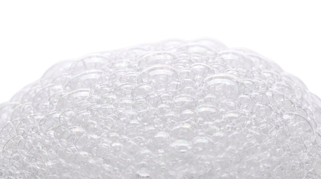 Soapy foam texture made of countless tiny spherical spheres creating a soft bubbly layer reflecting light across the surface during a relaxing bath time routine involving liquid soap suds