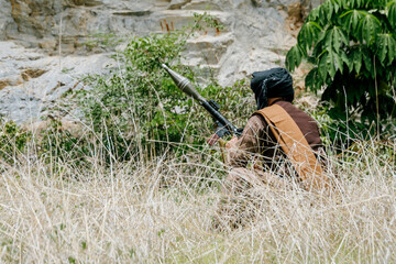 Naklejka premium Focused outdoor soldiers on duty in jungle display determined expression while armed with weapon within rugged wilderness