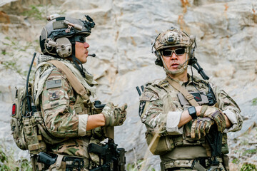 Outdoor scene with focused soldiers in jungle on duty showing alert and watchful emotional...