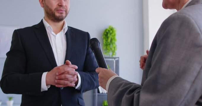 Close-up of reporter interviewing celebrity guest with microphone, sparking lively conversation for press and pr amid a dynamic media scene filled with engaging talk and vibrant communication energy.