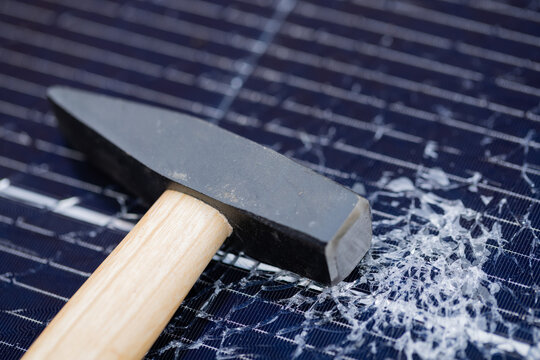 Hammer on Smashed Solar Panel with Shattered Glass