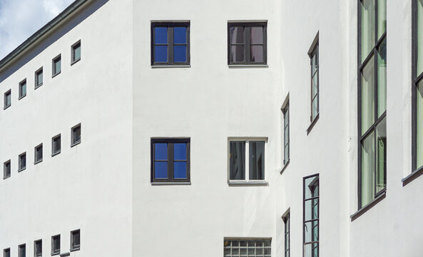Oslo white building facade with windows reflecting blue sky