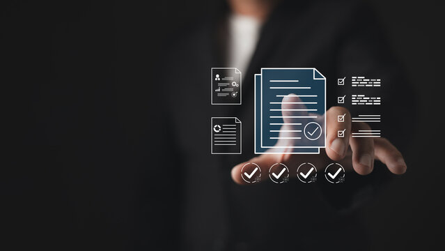 Businessman touching virtual document icon with checkmarks. Digital contract approval, paperless quality control, electronic signature, and online business compliance audit concept.