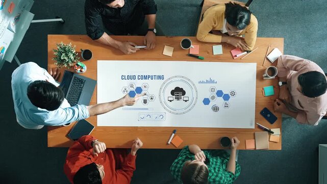 Collaborative Team Meeting on Cloud Computing Strategies with Diverse Group of Professionals Analyzing Visual Data on a Large Table. Entropy.