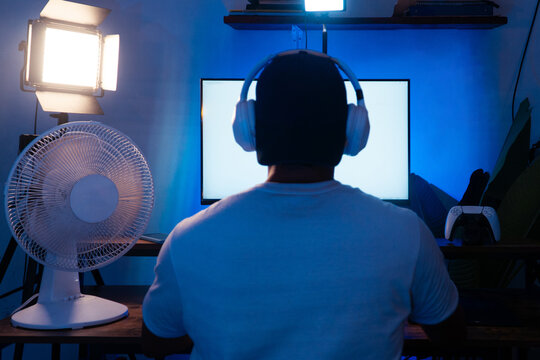 Person streaming video game in neon lit room
