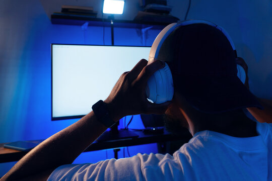 Young person enjoying digital entertainment at night