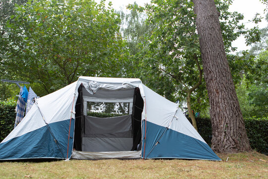 Camping with family in a tent in nature setting during vacation trip