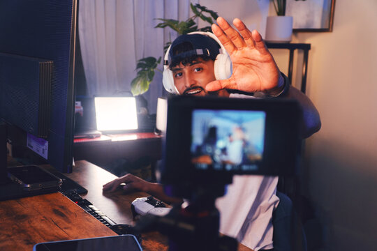 Hispanic male streamer greeting audience during live video