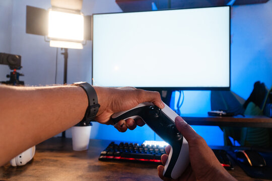 Hispanic man playing video game with controller