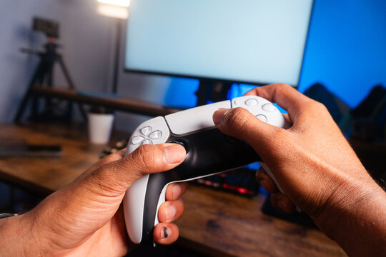 Person holding gaming controller playing video game