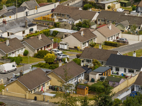 Aerial view of St Patrick's Church surrounded by residential houses, gardens, and streets in Portlaw, County Waterford, Ireland.