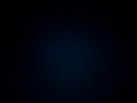 Faint Stars Glowing Across Dark Blue Night Sky