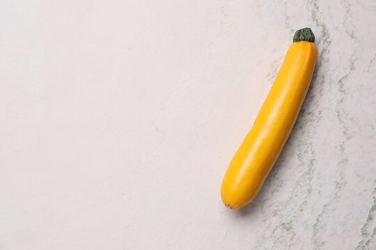 Fresh raw zucchini on light table, top view. Space for text
