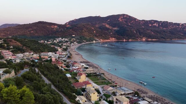 Aerial Panorama of Agios Georgios Pagon Bay, Sandy Beach and Green Hills at Sunset, Corfu Island, Greece