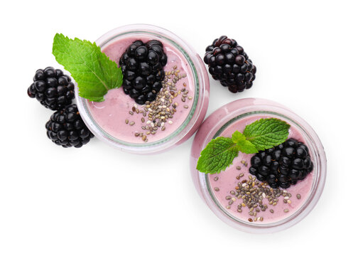 Tasty blackberry smoothies with mint and chia seeds in glasses isolated on white, top view