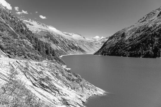 Beautiful alpine walley with azure blue water of Speicher Zillergrundl dam, Zillertal Alps, Austria. Black and white Photography