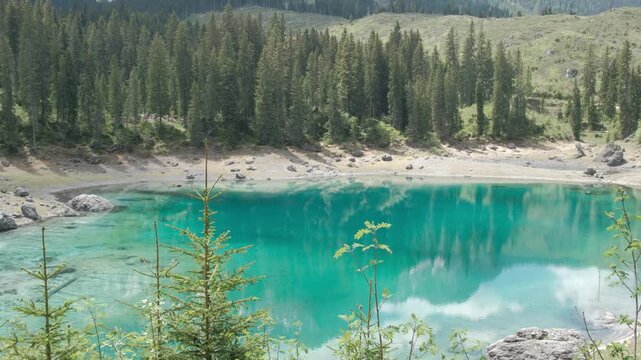 Turquoise Alpine Water of Lago di Carezza Surrounded by Pine Forest in South Tyrol Italy