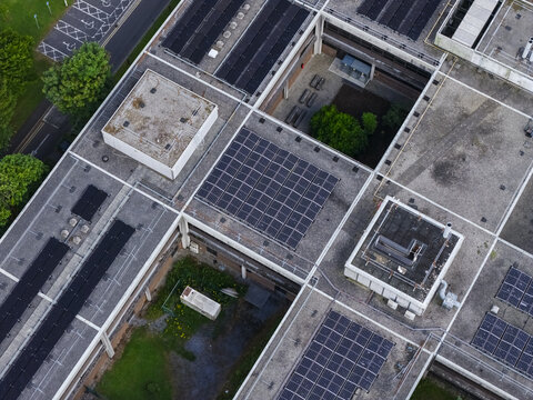Aerial view of University of Galway Research and Innovation Centre featuring flat roofs with solar panel arrays and internal courtyards in Galway, County Galway, Ireland.