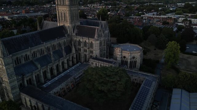 Drone pull back shot of historic cloisters and courtyard at Salisbury Cathedral