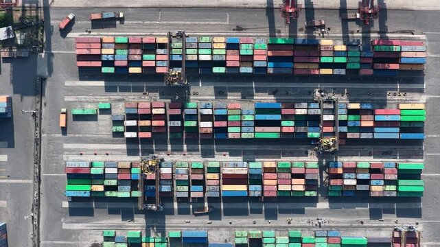 Colorful shipping containers stacked in neat rows at a logistics terminal in Banjarmasin Indonesia