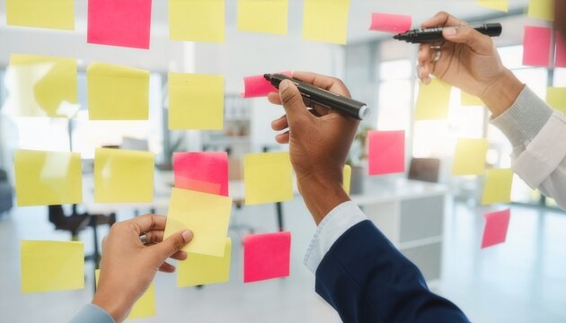 Diverse Professional Team Brainstorming Strategy Using Colorful Sticky Notes on Glass Board