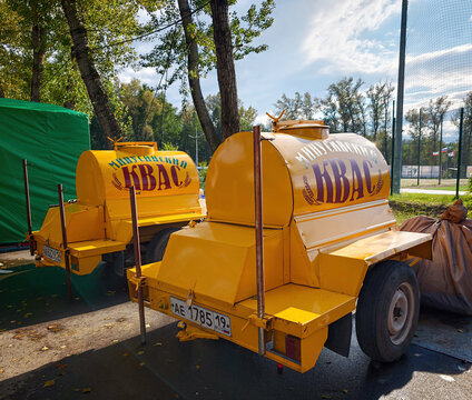 Traditional yellow tanker trailers (barrels) with a capacity of 900 litres, which are used for the delivery and street sale of kvass: Abakan, Russia - August 15, 2026