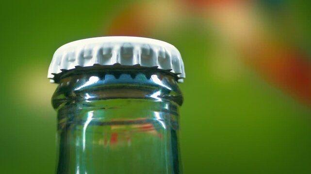Beer Bottle With Sports On TV Behind
