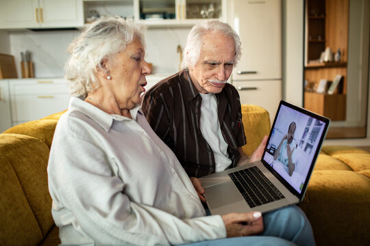 Senior couple having online doctor consultation at home