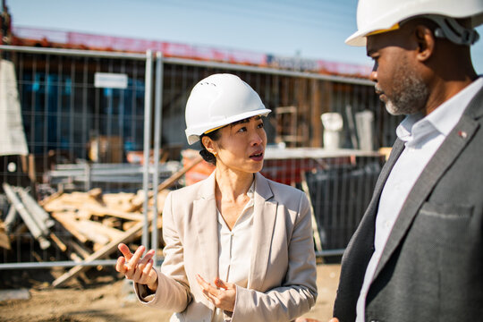 Engineers discussing project at construction site