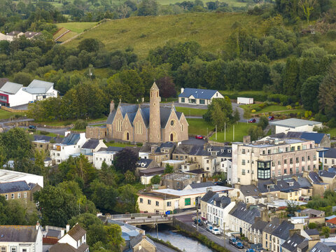 Aerial view of St. Patrick's Church surrounded by lush green hills and the townscape of Donegal, County Donegal, Ireland.