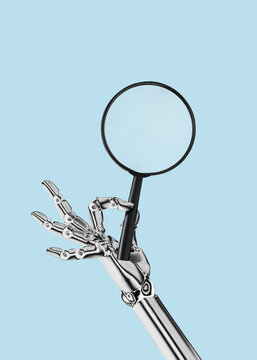 White cyborg robotic hand holds a magnifying glass in his finger - Using AI and chatbots to search for information - isolated on free blue background.