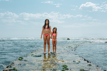 Two Smiling girls Exploring the Coast Together on a Sunny Summer Day © Victoria
