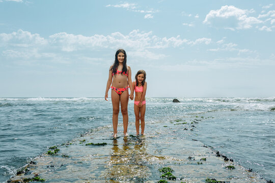Two Smiling girls Exploring the Coast Together on a Sunny Summer Day