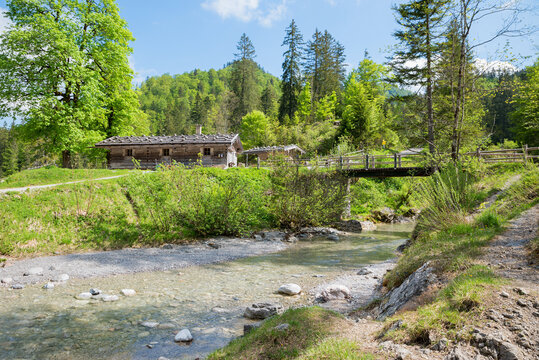 Siebenhutten hiking destination Kreuth, Weissach river with bridge, spring landscape