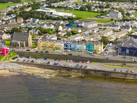 Aerial view of the colorful row of houses and the historic church along the coastline, Bundoran, County Donegal, Ireland.