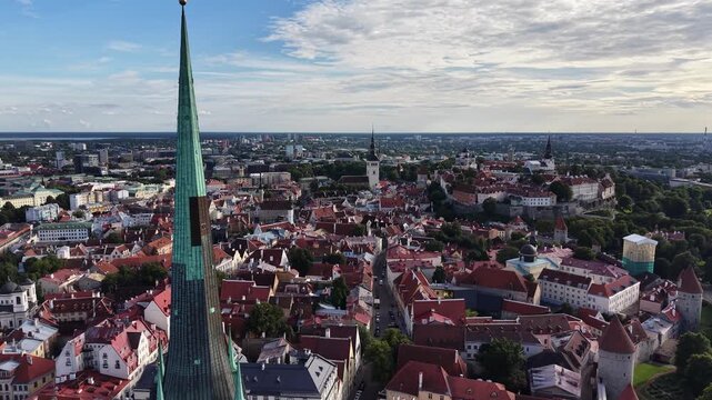 Drone shot focusing on St Olaf's Church spire in Tallinn Old Town, Estonia