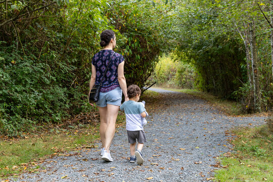 Mother And Son Walking On Forest Trail At Great Blue Heron Nature Reserve Chilliwack BC Canada