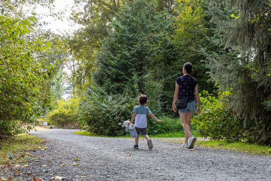Mother And Child Walking on Forest Trail at Great Blue Heron Nature Reserve, Chilliwack, BC Canada
